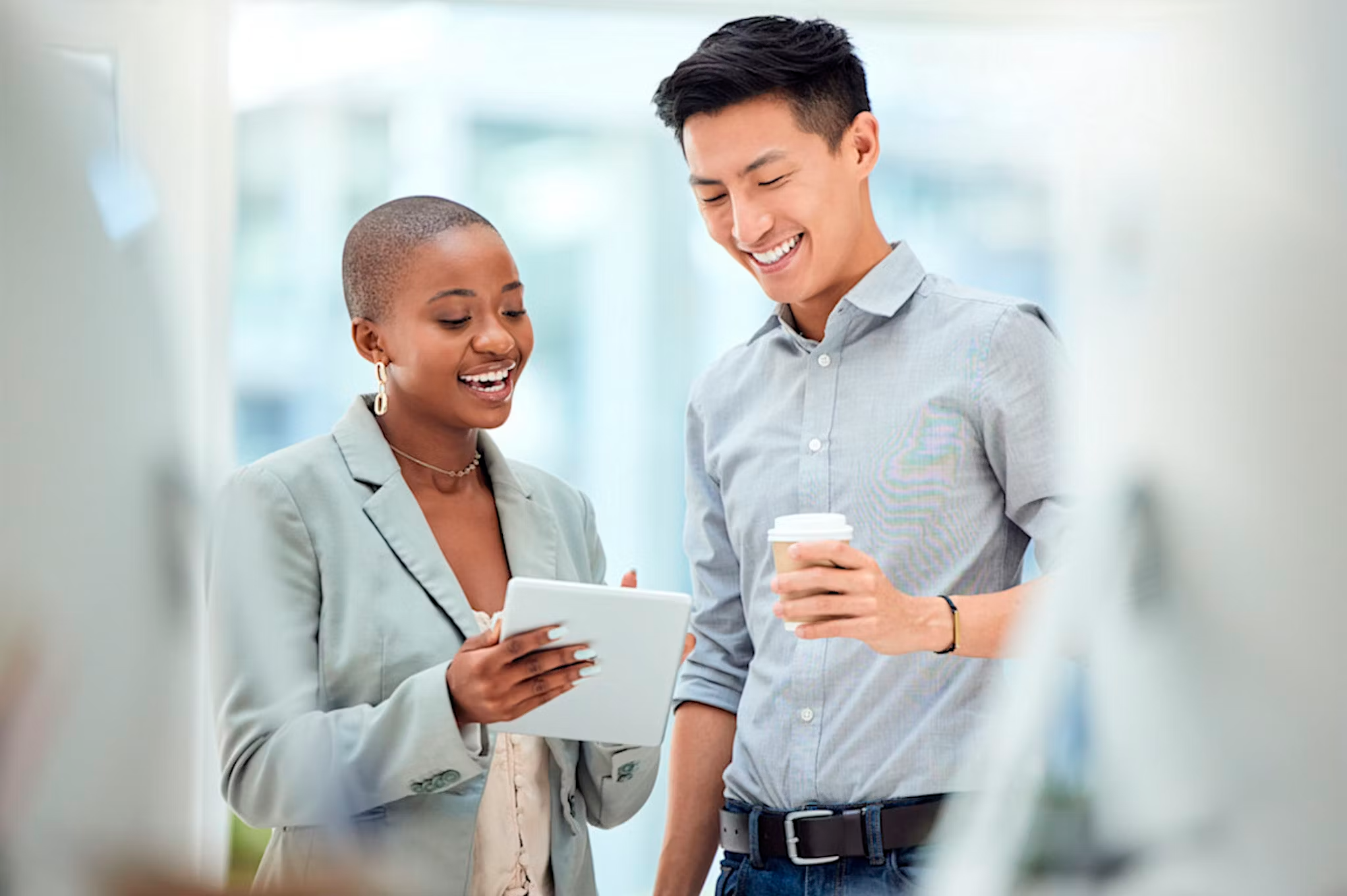 Two professionals in a modern office reviewing CRM automation workflows with AI software – FlowiLab digital automation consultancy